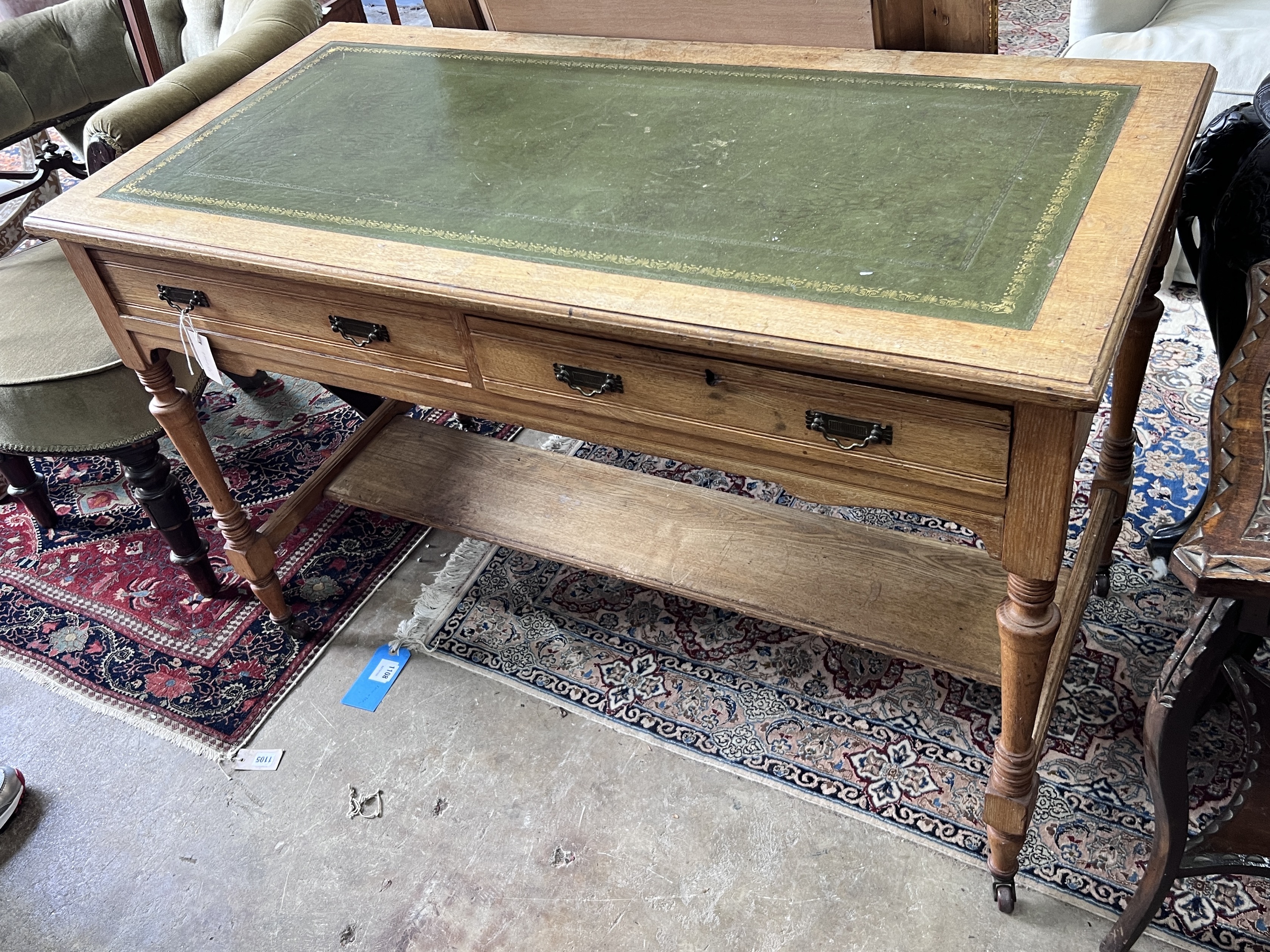 A late Victorian light oak two drawer writing table, width 120cm, depth 59cm, height 78cm